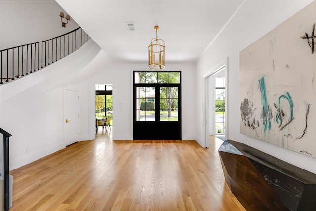 foyer entrance with light wood-type flooring and french doors