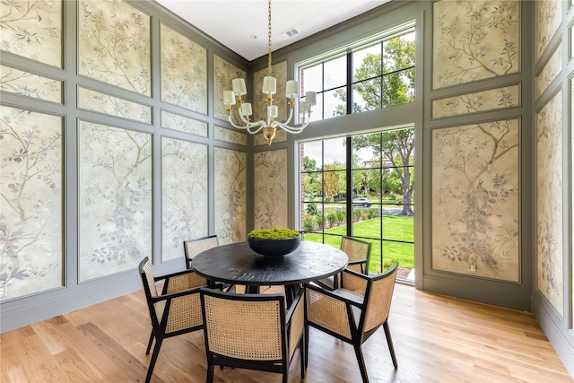 sunroom featuring a notable chandelier