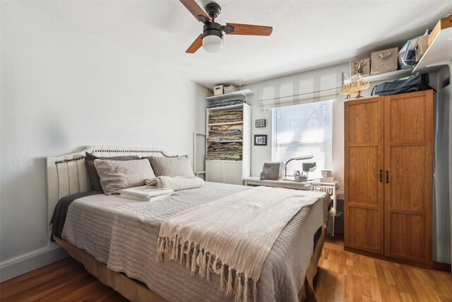 bedroom with wood-type flooring and ceiling fan