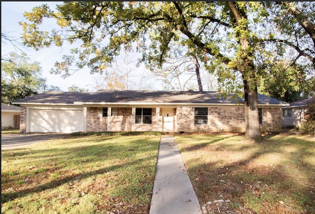 single story home featuring a garage and a front yard