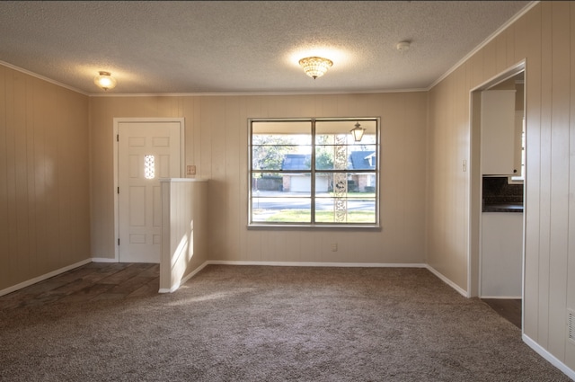 carpeted entrance foyer featuring ornamental molding