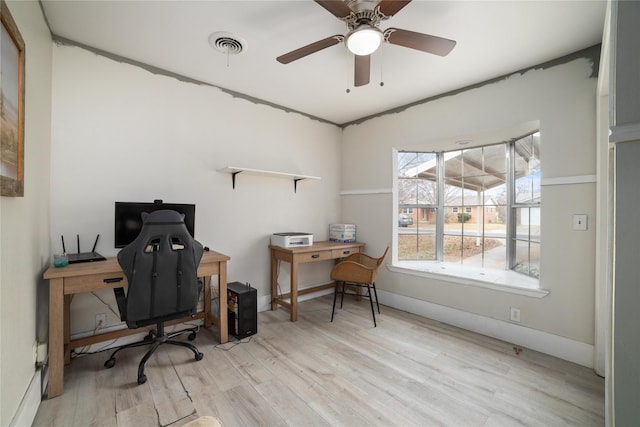 office area with light wood-type flooring and ceiling fan