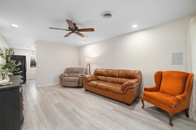 living room featuring ceiling fan and light hardwood / wood-style floors