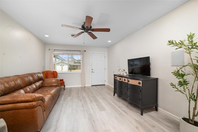 living room with ceiling fan and light hardwood / wood-style floors