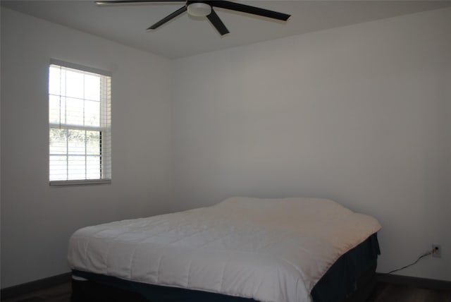 bedroom featuring dark hardwood / wood-style flooring and ceiling fan