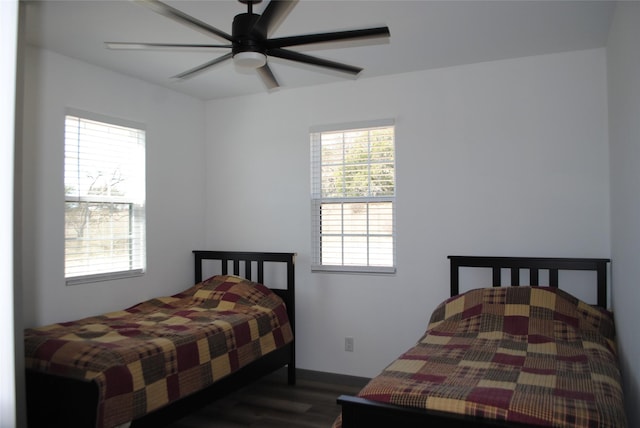 bedroom with dark wood-type flooring and ceiling fan