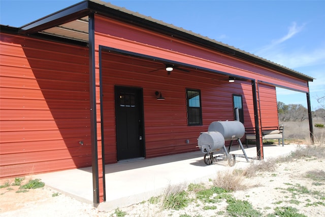 rear view of property featuring an outdoor structure