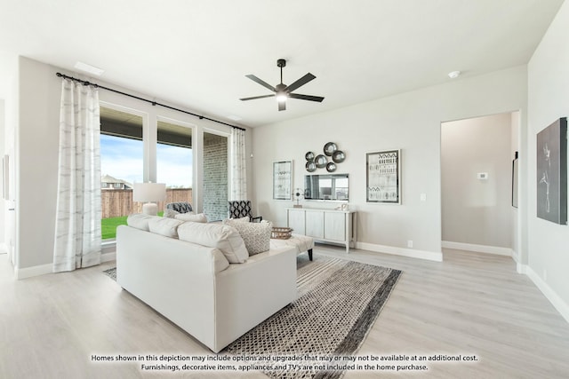 living room with ceiling fan and light hardwood / wood-style floors