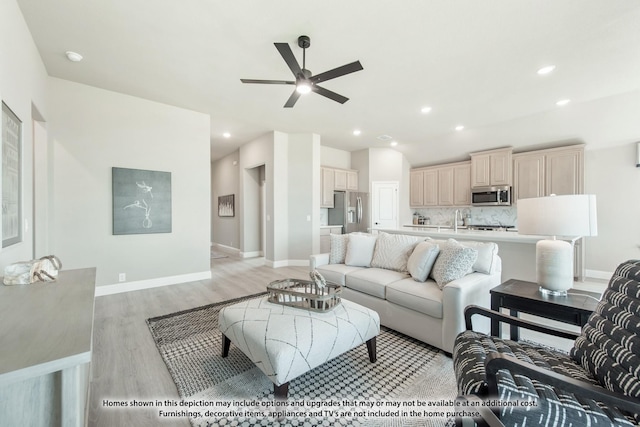 living room with light hardwood / wood-style flooring and ceiling fan