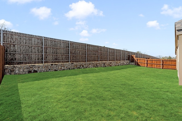 view of yard with a fenced backyard