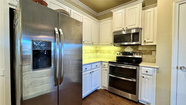 kitchen with white cabinets, appliances with stainless steel finishes, backsplash, and ornamental molding