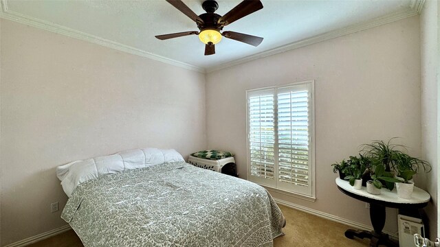 bedroom with carpet floors, ceiling fan, and ornamental molding