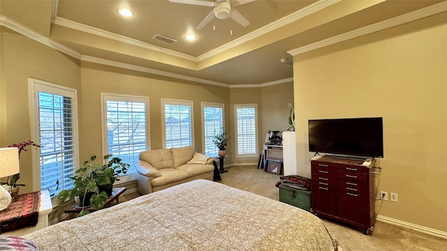 carpeted bedroom featuring a tray ceiling, ceiling fan, and crown molding