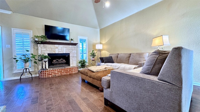 living room with dark hardwood / wood-style floors, ceiling fan, lofted ceiling, and a fireplace