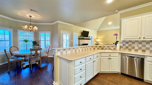 kitchen featuring kitchen peninsula, stainless steel dishwasher, sink, a notable chandelier, and white cabinets