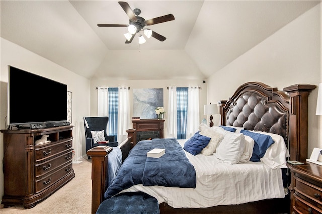 carpeted bedroom featuring ceiling fan and vaulted ceiling