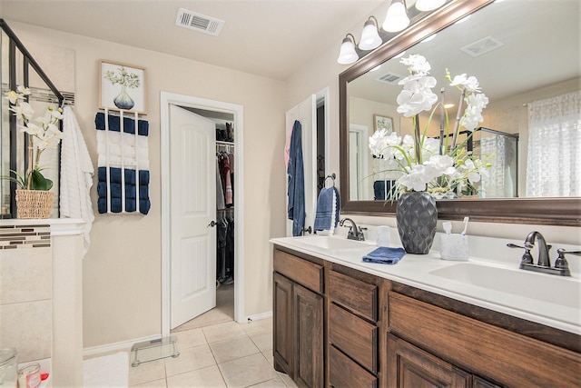 bathroom with tile patterned flooring, vanity, and a washtub