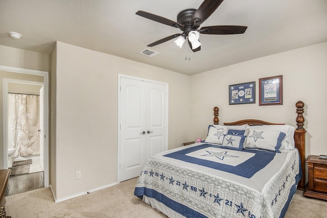 carpeted bedroom featuring ceiling fan and a closet