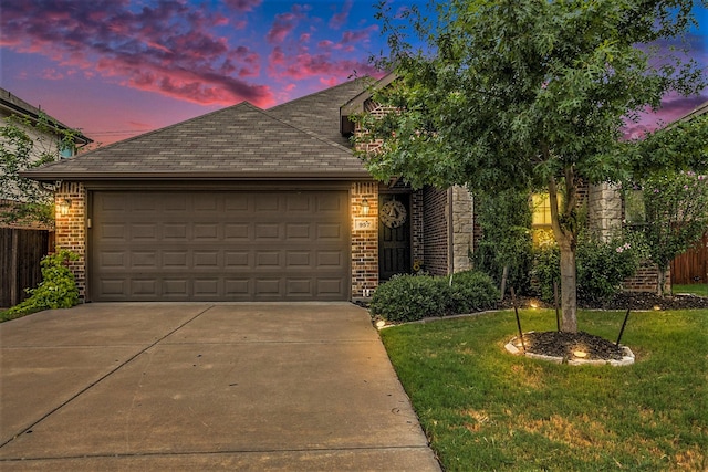 view of front of home with a yard and a garage