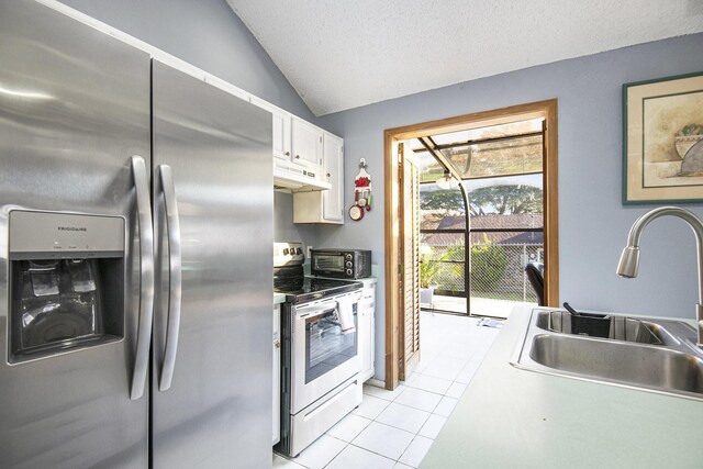 kitchen featuring stainless steel fridge, vaulted ceiling, sink, electric range, and white cabinets