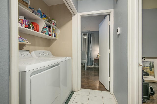 washroom featuring light tile patterned floors and washing machine and clothes dryer