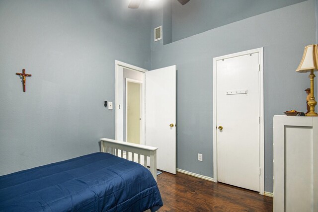 bedroom with ceiling fan and dark wood-type flooring