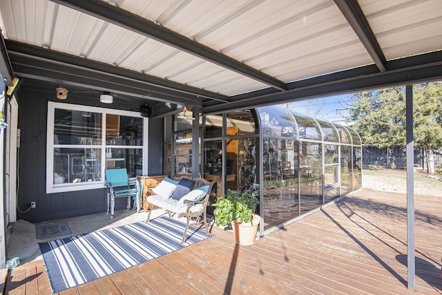 wooden deck with a sunroom