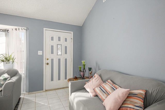 tiled living room with a textured ceiling and vaulted ceiling