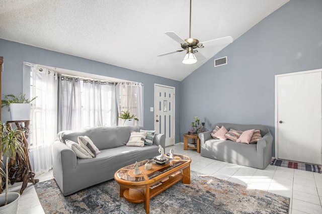 tiled living room featuring ceiling fan, a healthy amount of sunlight, a textured ceiling, and high vaulted ceiling