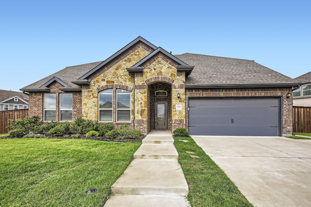 view of front of house with a garage and a front yard