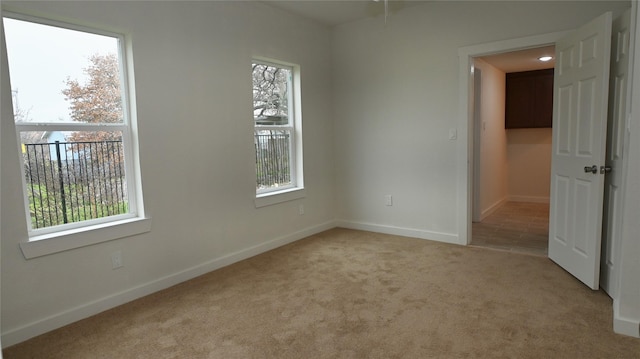 spare room with light colored carpet