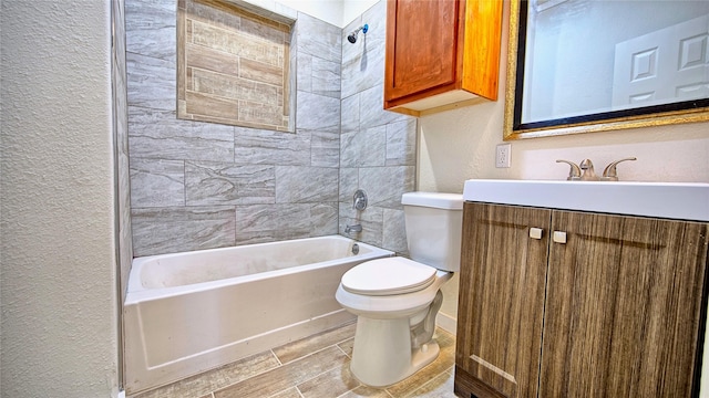 full bathroom featuring vanity, toilet, and tiled shower / bath