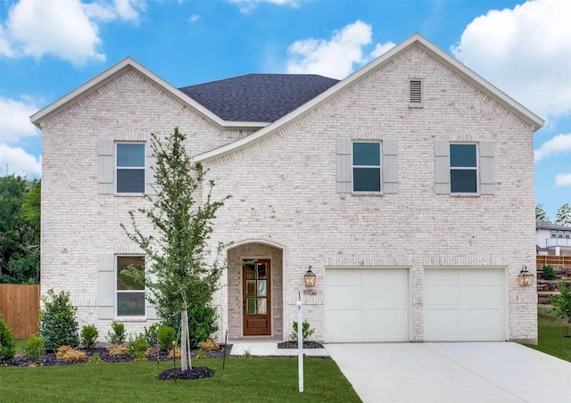 view of front of property with brick siding, roof with shingles, an attached garage, driveway, and a front lawn