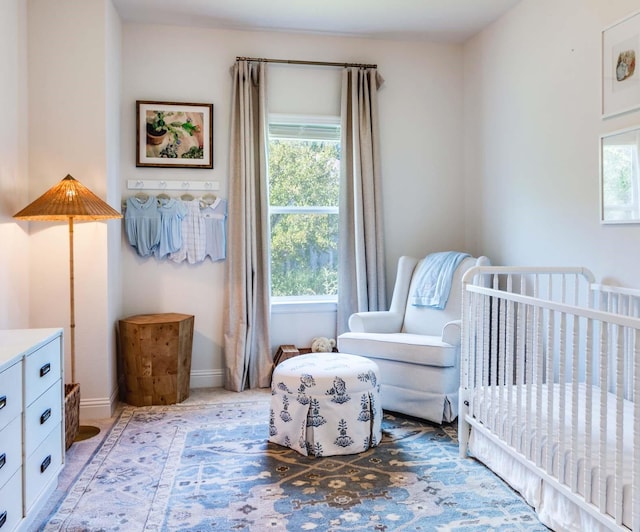 bedroom with a crib and baseboards