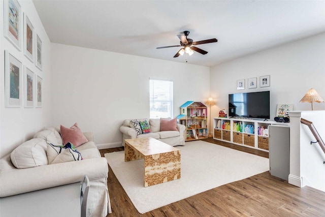 living room featuring ceiling fan and wood finished floors