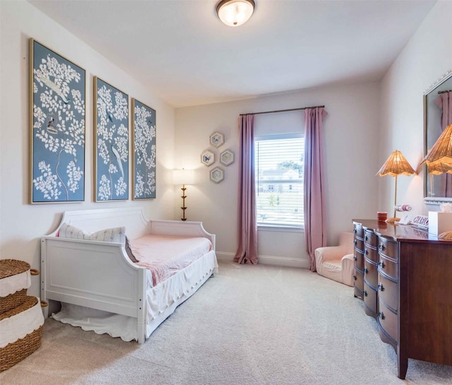 bedroom with light carpet and baseboards