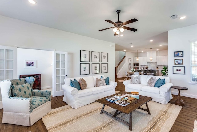 living room with hardwood / wood-style flooring and ceiling fan