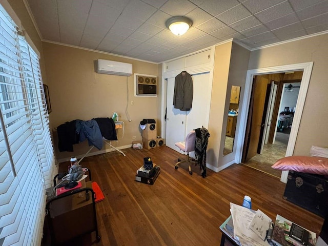 interior space featuring crown molding, an AC wall unit, and hardwood / wood-style floors