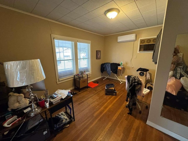 interior space featuring ornamental molding, a wall mounted air conditioner, and hardwood / wood-style floors