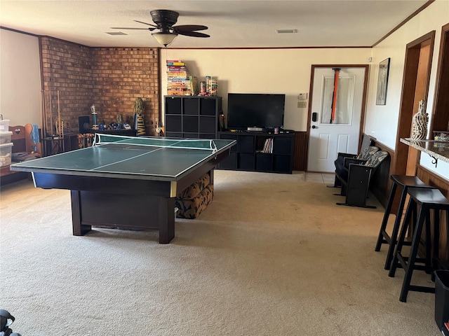 playroom with light carpet, ceiling fan, and ornamental molding