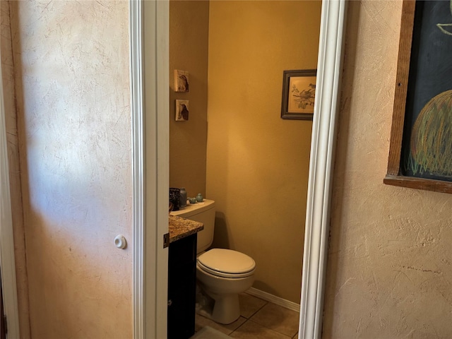 bathroom featuring tile patterned flooring, vanity, and toilet