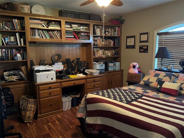 bedroom with dark hardwood / wood-style floors and ceiling fan