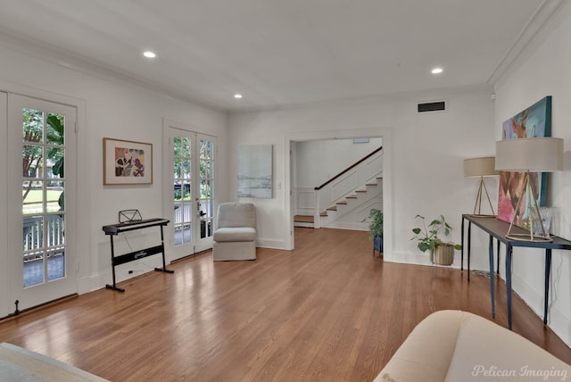 sitting room featuring french doors, hardwood / wood-style floors, and ornamental molding