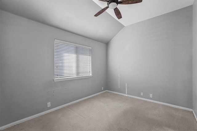 carpeted spare room with ceiling fan and lofted ceiling