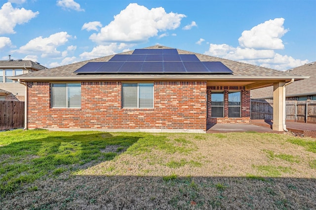 back of property featuring a patio and a lawn