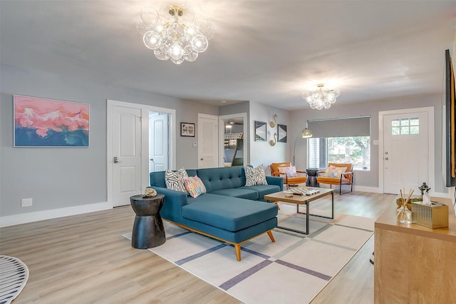 living room with a chandelier and light hardwood / wood-style floors