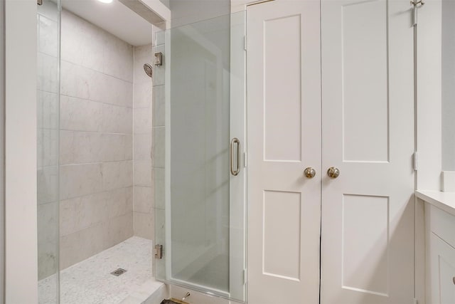 bathroom with vanity and a shower with shower door