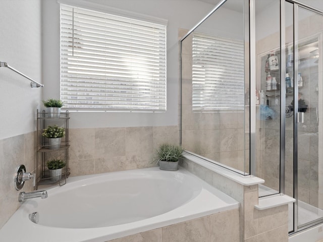 bathroom with independent shower and bath and plenty of natural light