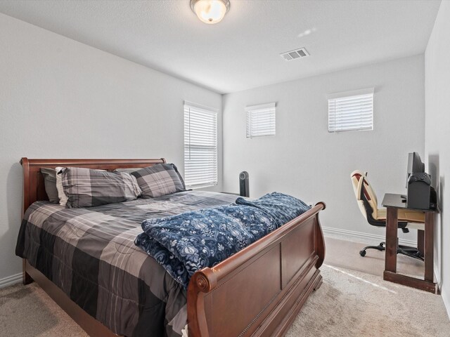 bedroom featuring light carpet