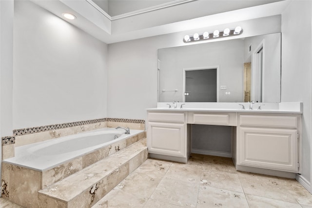 bathroom featuring vanity and tiled bath